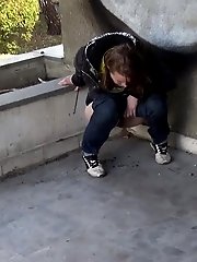 15 pictures - Cute girl in denims pisses onto the concrete