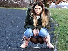 0  - Cute brunette squats to piss on a path in the city