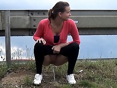 0  - Brunette squats by a busy road and pisses