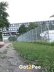 15 pictures - Stunning dark haired babe sprays her piss outside
