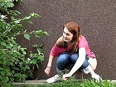 0  - Redhead pisses in public behind a building