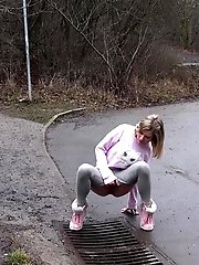 15 pictures - Blonde babe Claudia pisses down a drain outside