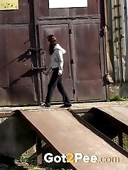 15 pictures - Gorgeous brunette filmed twice pissing outside