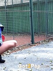 15 pictures - Brunette squats low to piss outside