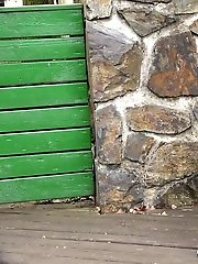 15 pictures - Pretty babe pisses onto a wooden terrace