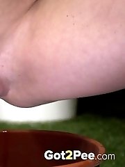 15 pictures - Gorgeous European pisses into a plant pot outside