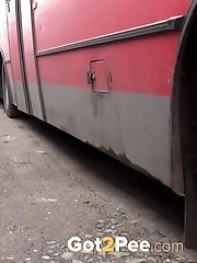 15 pictures - Sexy blonde girl pisses between parked buses
