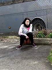 15 pictures - Dark haired girl pisses by a public car park